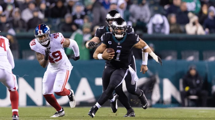 Jan 8, 2023; Philadelphia, Pennsylvania, USA; Philadelphia Eagles quarterback Jalen Hurts (1) runs with the ball in front of New York Giants linebacker Tomon Fox (49) during the third quarter at Lincoln Financial Field.